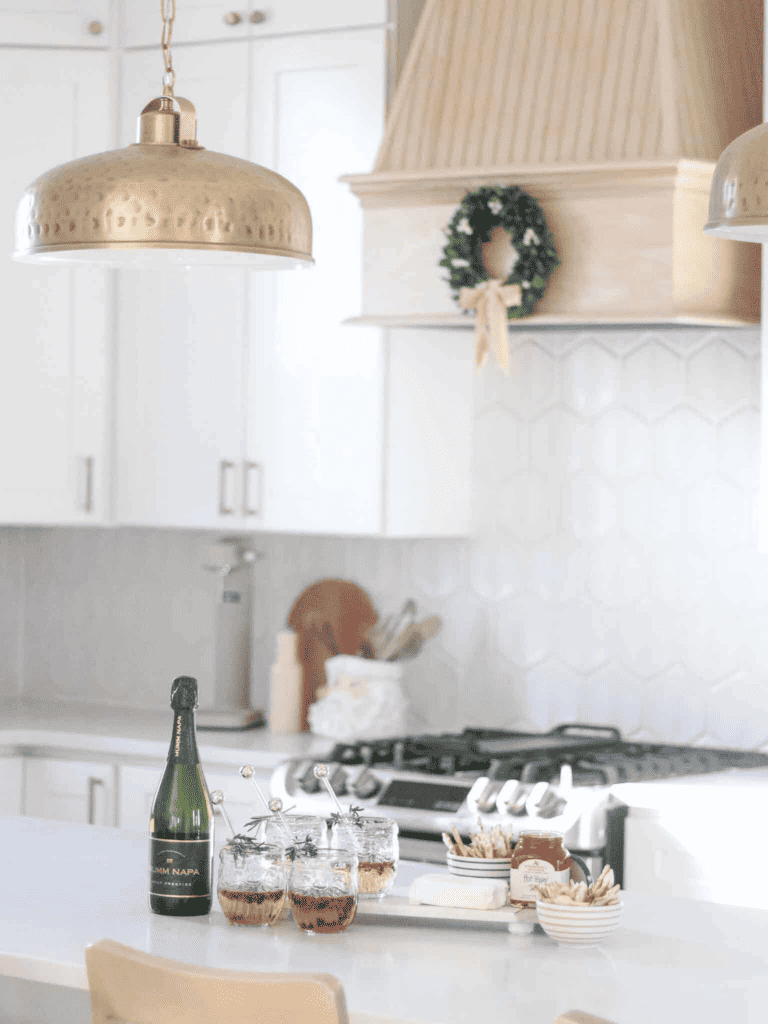 Champagne and board spread on white kitchen countertop