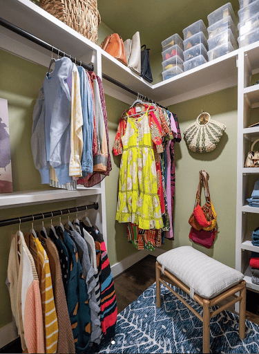 Colorful closet with purses hanging on wall