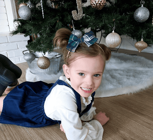 Little girl under christmas tree