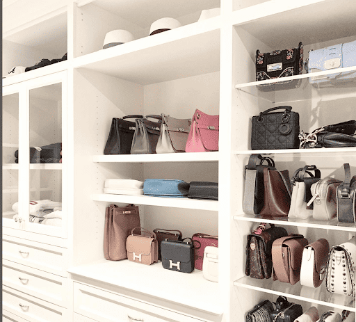Purse collection on shelves in a closet