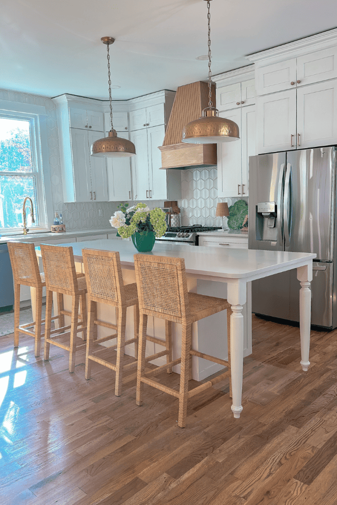 White kitchen with natural rattan chairs