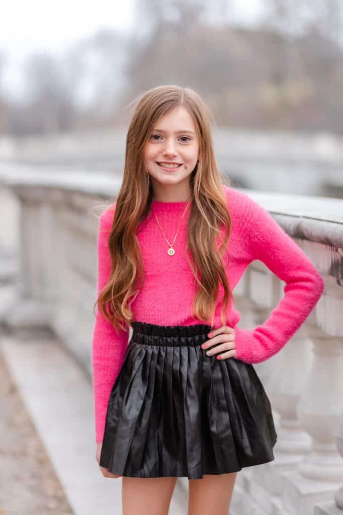 Family Photoshoot Outfit Ideas To Wear In Winter young girl in pink and black
