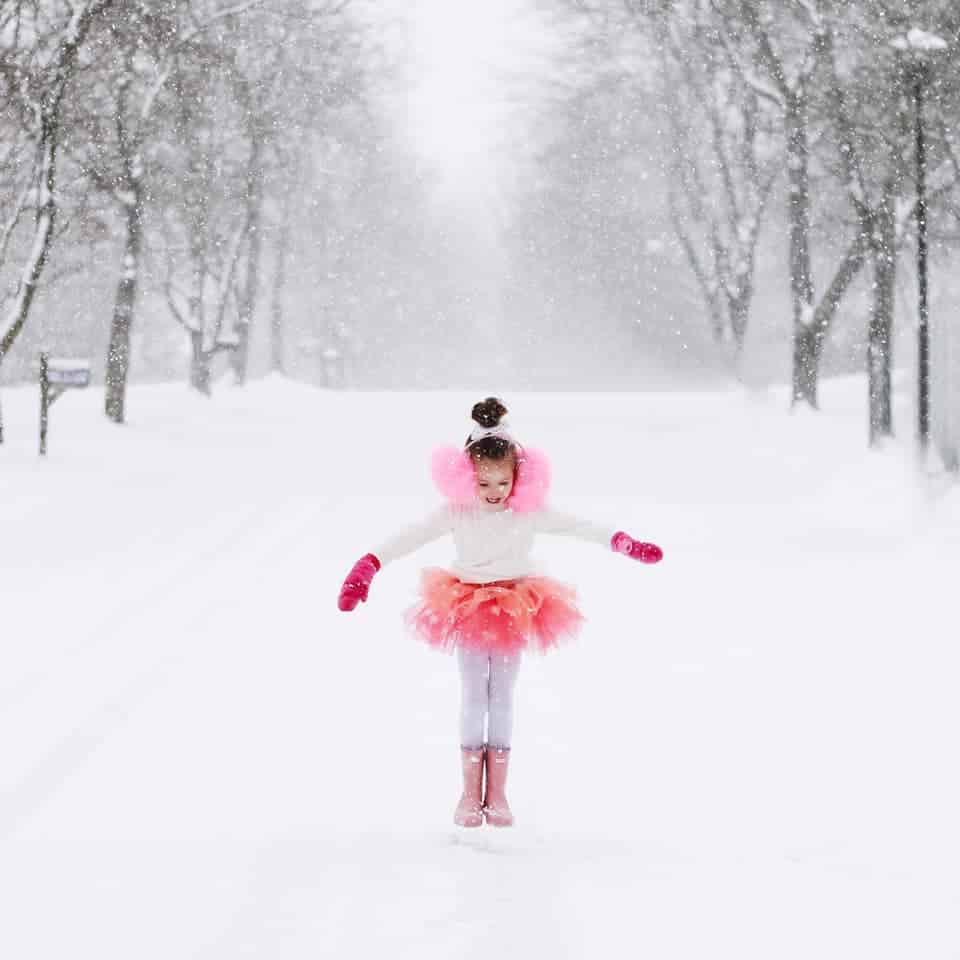 girl in snow in pink tutu