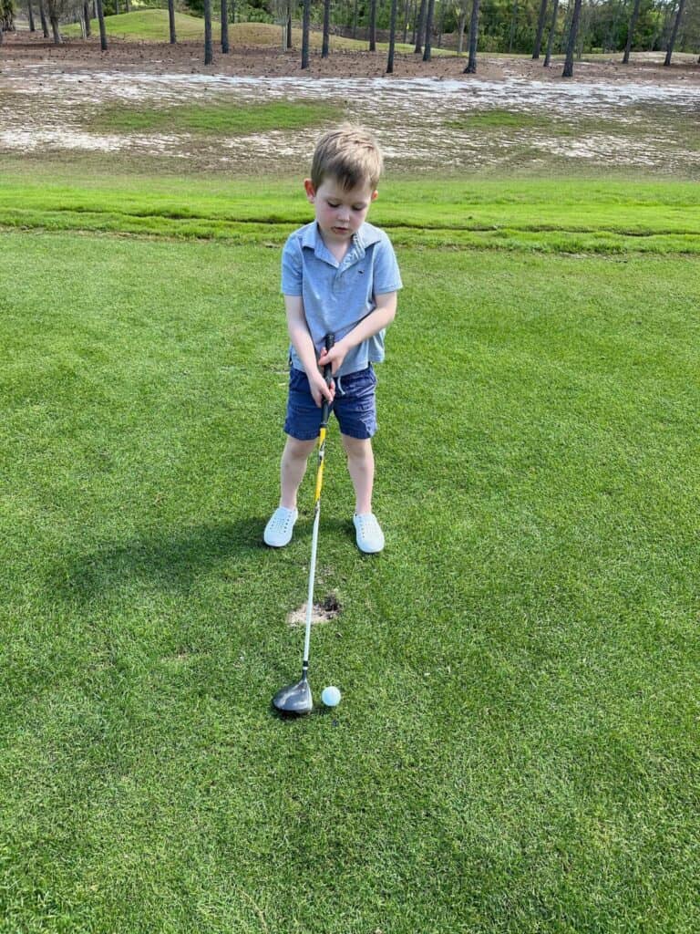 Boy playing golf in Gulf Coast