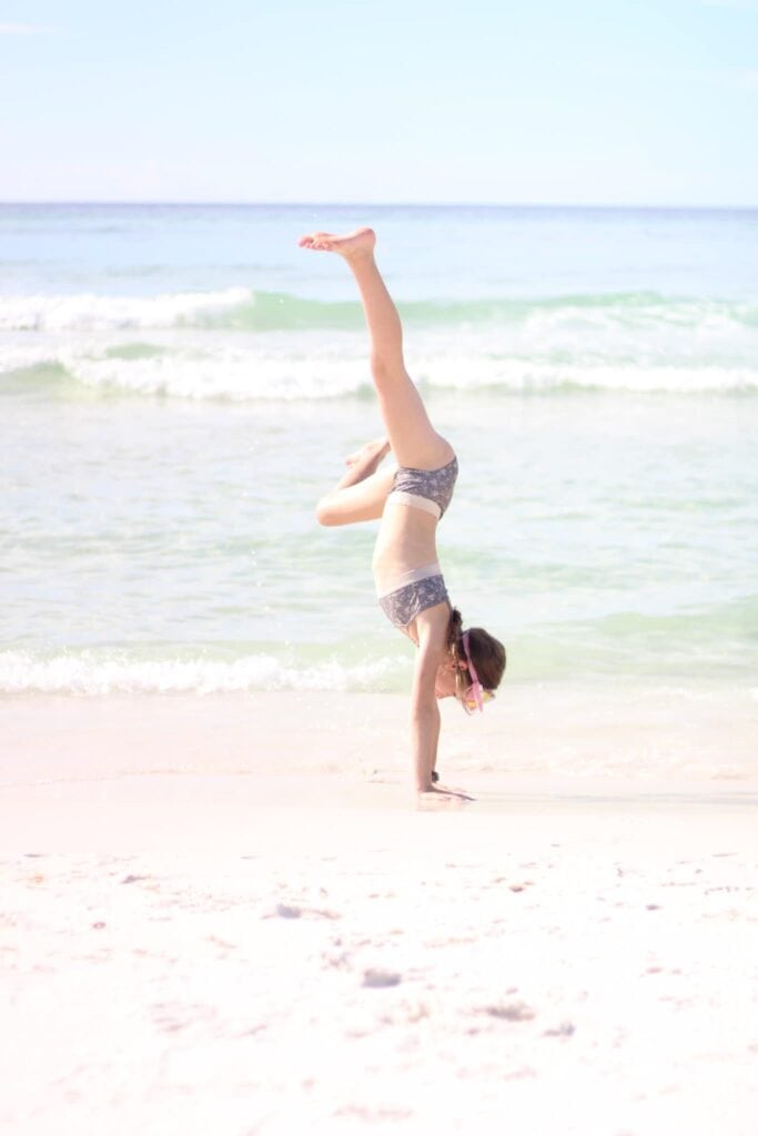 Girl handstand at beach