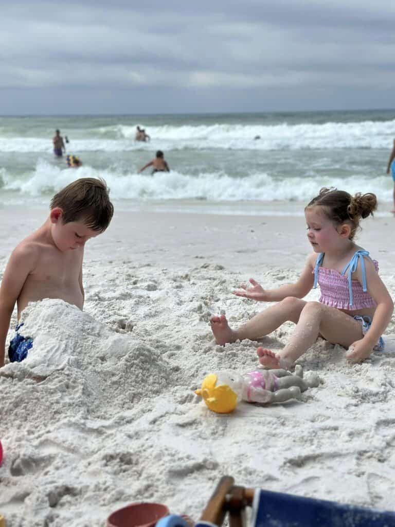 kids playing in sand at the beach