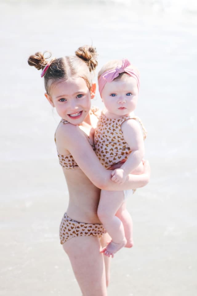 sisters at beach in leopard print